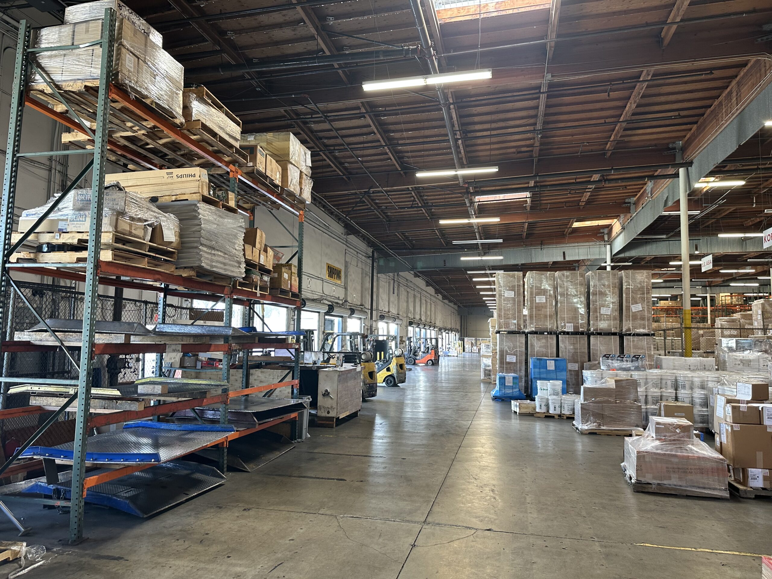 A warehouse filled with lots of boxes and shelves.